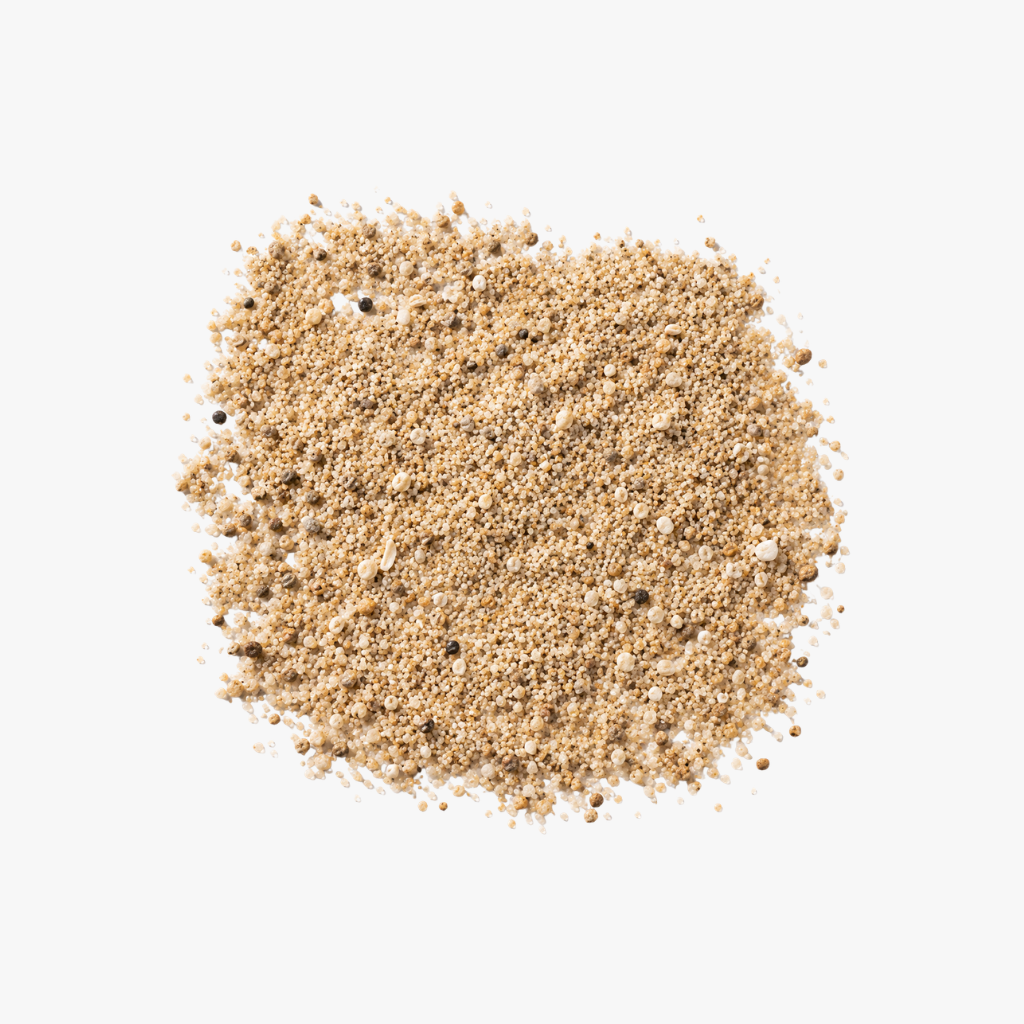  Close-up of fine sand grains, representing the Sand tempered glass furniture collection