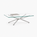 Rectangular glass coffee table polished chrome starburst base styled with art book